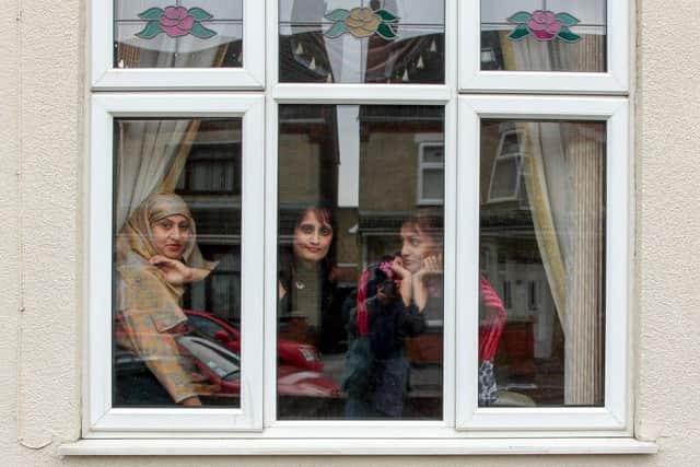 Picture shows Out from behind the Curtains  Reunion pic January 2013.  (left-right) Shehnaz Begum, her twin sister Rukhsana and their older sister Itrat were spotted sitting in the window of their house at 100 Cromwell Road in Peterborough in 1980. We often used to perch in the window and watch what was going on in the road, said Shehnaz. My twin sister and I were about seven and Itrat was nine.
