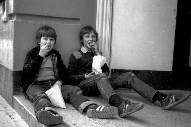 Picture titled Eating Chips  Original Pic 1983 School friends Martin Coulson (left) and Andy Randall were eating chips bought from the arcade which has now been replaced with Wilkinsons in Peterborough.. I think it must have been a Saturday and wed been to the chip shop. The chips were a bit like McDonalds fries and were always good, said Martin, who was a warehouse manager and is currently re-training. He is married with two children. Andy is a telematics engineer and is married with three children.
