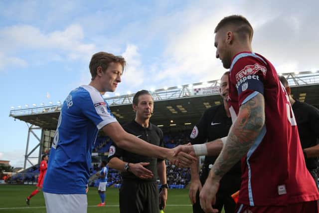 Captains Chris Forrester (Posh) and Bruce Wilson shake hands before the first round FA Cup tie. Photo: Joe Dent/theposh.com.