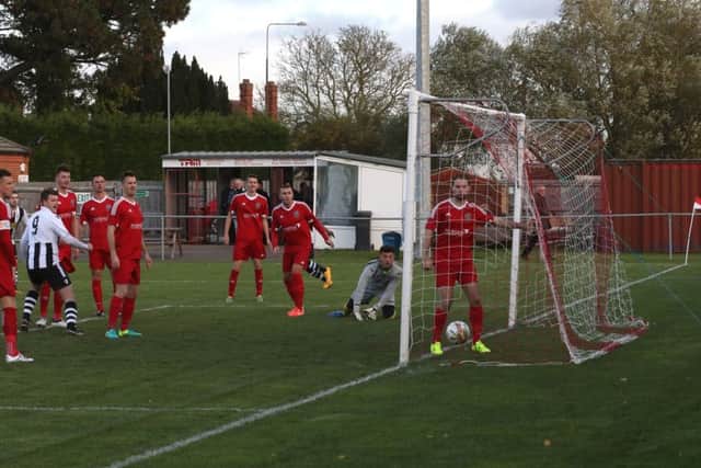 Matt Barber's deflected shot has just nestled in the back of the net to give Peterborough Northern Star the lead at Wisbech. Photo: Tim Gates.