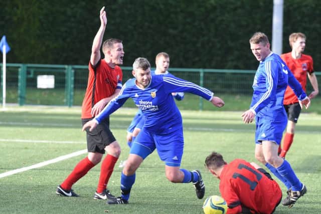 Action fron AFC Stanground Sports (blue) against Pinchbeck. Photo: David Lowndes.