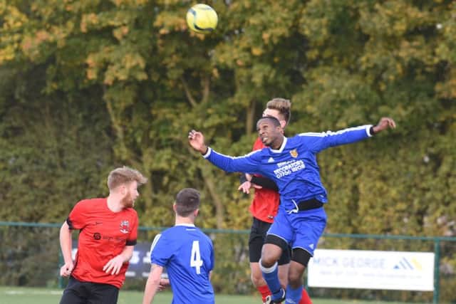 AFC Stamground Sports' striker Dwayne Rankin challenges for a high ball in the 3-1 defeat at the hamds of Pinchbeck. Photo: David Lowndes.