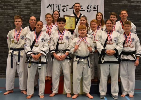 The Market Deeping Tang Soo Do Club members who did well in the Netherlands Open. They are Gabe Howlett, Ian Williams, Sarah Chapman, Freya Newman, Leah Smith, Tom Roberts, Master Robbie Tyler, Laurence Sutton, Emily Meli, Thomas Sutton, Mia Newman, Lauren Bettyes, Max Meli, Phillip Sutton and James Roberts.