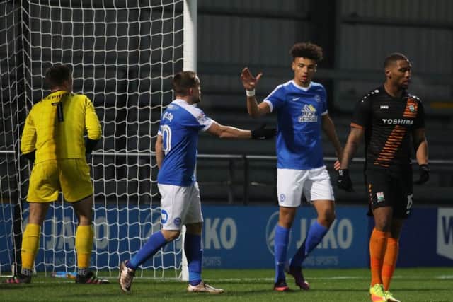 Posh striker Lee Angol (right) congratulates Paul Taylor on his goal against Barnet. Photo: Joe Dent/theposh.com.