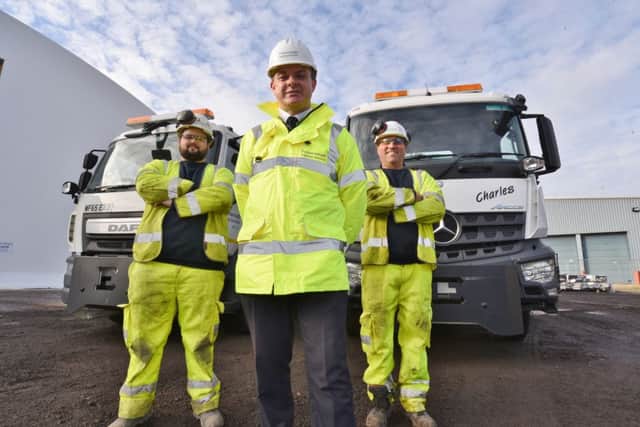 The Peterborough City Council Gritting shed at Fengate with their new vehicles. Pictured are drivers Ryan Fowler and Martin Clements with Andy Tatt, head of Pboro Highways Services. EMN-160811-133324009