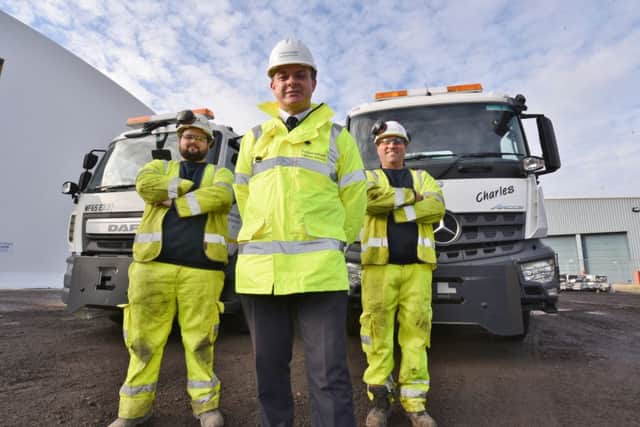 The Peterborough City Council  Gritting shed at Fengate with their new vehicles. Pictured are drivers  Ryan Fowler and Martin Clements with Andy Tatt, head of Pboro Highways Services. EMN-160811-133324009