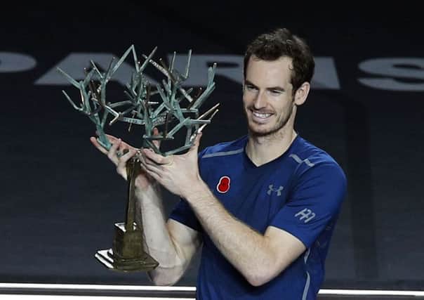 Andy Murray celebrates his rise to world number one after winning the Paris Masters.