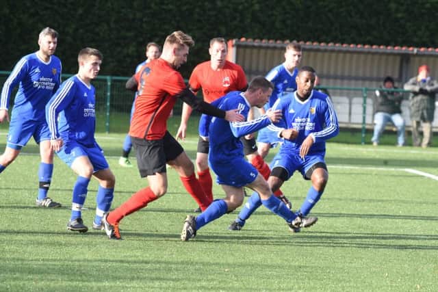 Action from Pinchbeck's win at AFC Stanground Sports (blue) in the Peterborough Premier Division. Photo: David Lowndes.