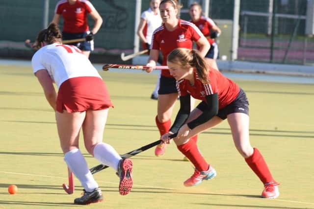 Di Bevan (red) created the first goal for City of Peterborough Ladies at Norwich Dragons.