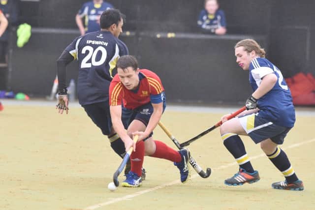 City of Peterborough skipper Ross Booth (red) in action against Ipswich. Photo: David Lowndes.
