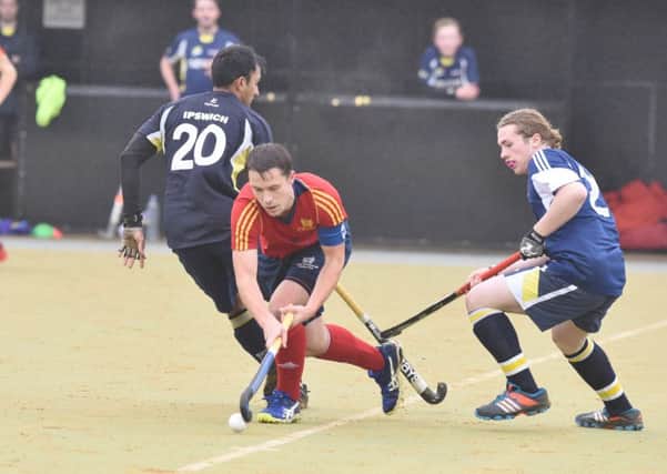 City of Peterborough skipper Ross Booth (red) in action against Ipswich. Photo: David Lowndes.