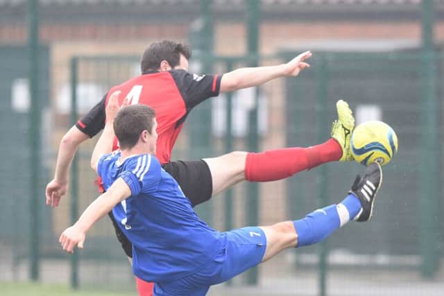 Ben Daly (red) in action for Netherton against AFC Stanground Sports. Photo: David Lowndes.