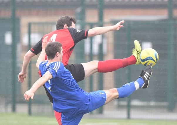 Ben Daly (red) in action for Netherton against AFC Stanground Sports. Photo: David Lowndes.