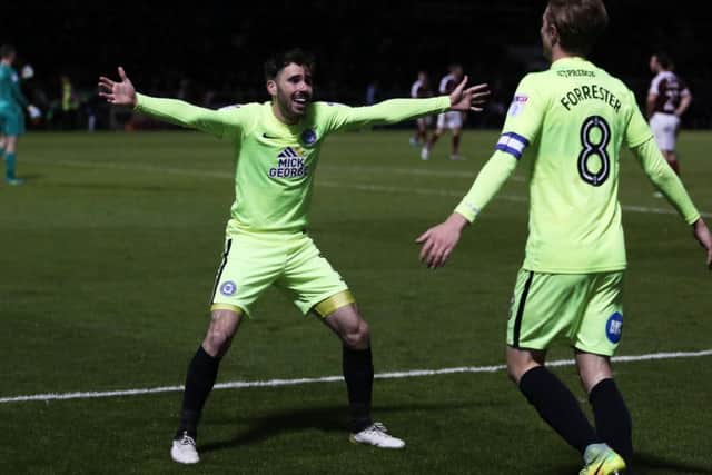Michasl Smith congratulates Posh skipper Chris Forrester after his late goal at Northampton. Photo: Joe Dent/theposh.com.
