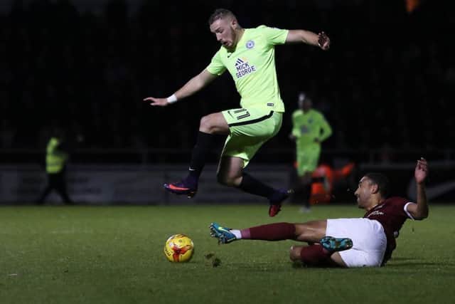 Posh star Marcus Maddison skips past Northampton centre-back Lewin Nyatanga. Photo: JoeDent/theposh.com.