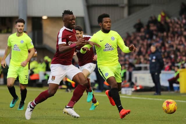 Posh striker Shaquile Coulthirst chases a ball in the company of Northampton's Gaby Zakuani. Photo: Joe Dent/theposh.com.