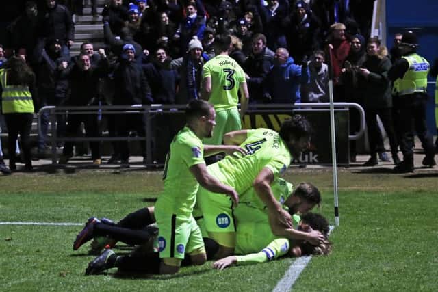 Posh players pounce pon Chris Forrester after his winning goal. Photo: Joe Dent/theposh.com.