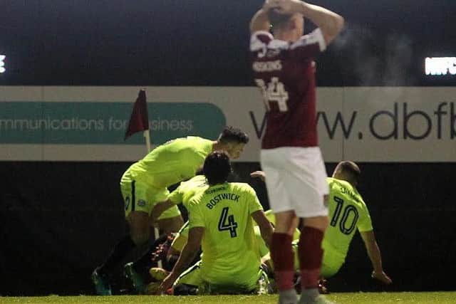 Posh players celebrate as Will Hoskins is distraught. Photo: Sharon Lucey.
