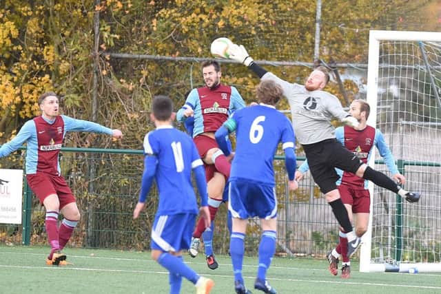 Action from Yaxley (blue) v Deeping Rangers. Photo: David Lowndes.