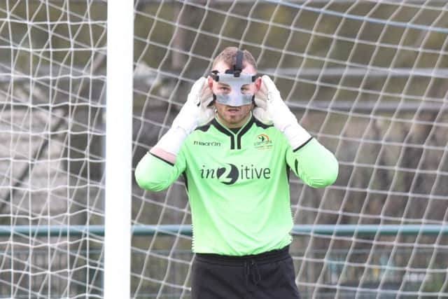 Yaxley goalkeeper Aaron Butcher wore a mask, to protect facial injuries suffered the previous week, in the game against Deeping Rangers yesterday. Photo: David Lowndes.