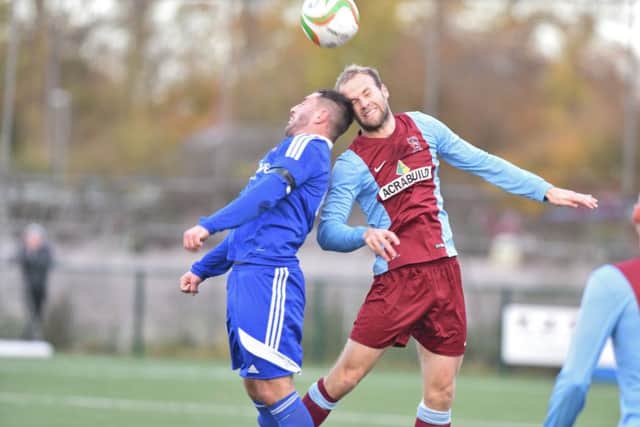 An aerial duel in the UCL Premier Division game between Yaxley and Deeping Rangers. Photo: David Lowndes.