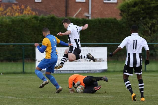 James Hill-Seekings of Peterborough Northern Star hurdles the Kirby Muxloe goalkeeper. Hill-Seekings scored both goals in a 2-0 win. Photo: Tim Wilson.