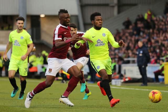 Gaby Zakuani challenges Posh striker Shaquile Coulthirst at Sixfields. Photo: Joe Dent/theposh.com.
