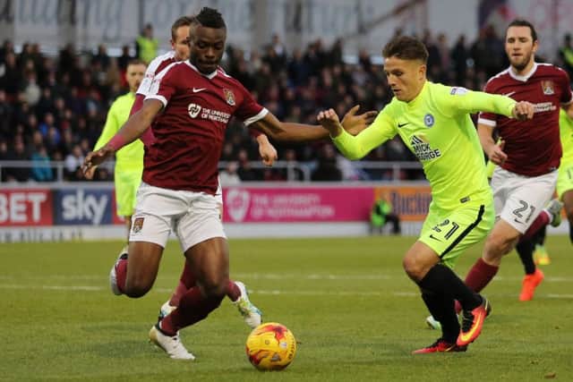 Gaby Zakuani in action against Posh striker Tom Nichols. Photo: Joe Dent/theposh.com.