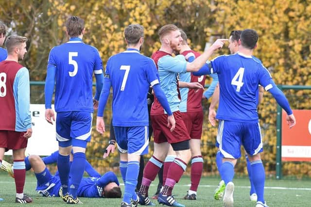 Action from Deeping's 4-1 win at Yaxley (blue). Photo: David Lowndes.