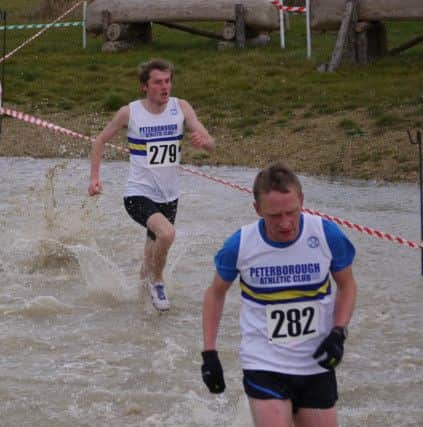 Steve Robinson leads Stuart Haw through the water.