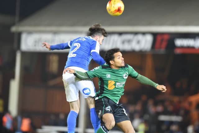 Posh right-back Michael Smith wins a header against Scunthorpe. Photo: David Lowndes.