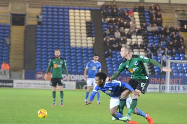 Posh striker Shaquile Coulthirst hits the deck after a tackle. Photo: David Lowndes.