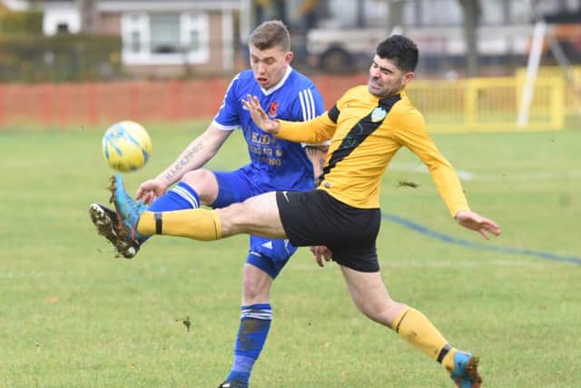 FC Peterborough and Brotherhood Sports players get stuck in to each other. Photo: David Lowndes.
