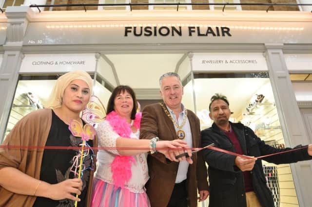 Nurum Ahmed at the opening of her shop in Westgate Arcade with Carole Hughes from Anna's Hope charity, Mayor David Sanders and  Mohammed Hakim, chairman of the Bangladesh Wefare Association in Peterborough EMN-161121-142949009