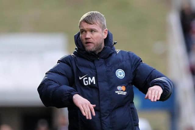 Posh boss Grant McCann has played down Posh achievements so far this season.