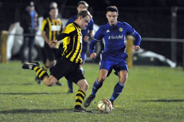 Action from Peterborough Sports' 4-1 win at Holbeach United (stripes). Photo: Tim Wilson.