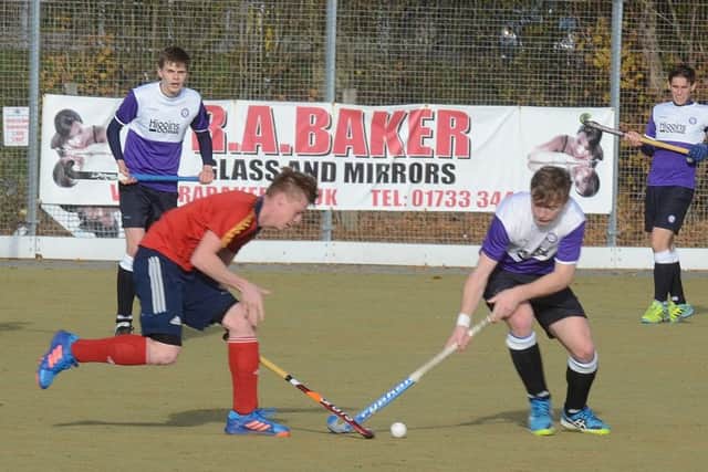 Two-goal Ross Ambler (red) in action for City of Peterborough against Old Loughtonians. Photo: David Lowndes.