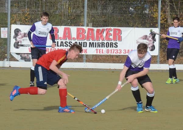 Two-goal Ross Ambler (red) in action for City of Peterborough against Old Loughtonians. Photo: David Lowndes.