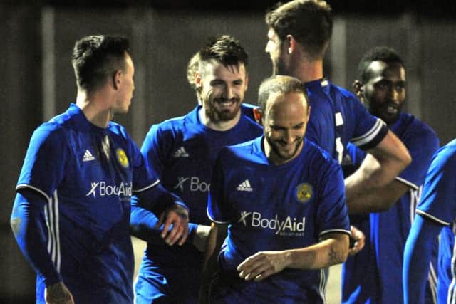Josh Moreman (grinning) scored twice for Peterborough Sports against Harborough.