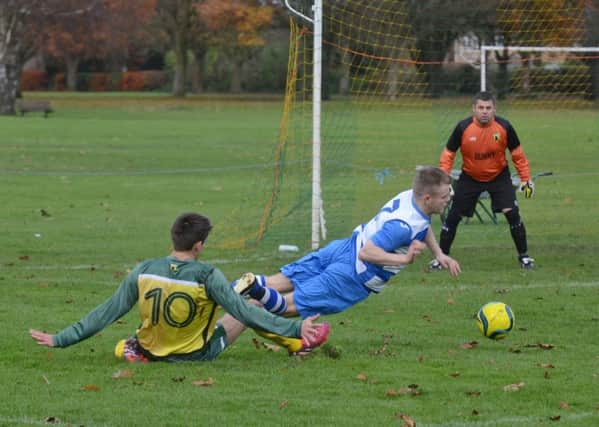 Action from the Peterborough Premier Division game between Crowland (yellow) and Leverington. Photo: David Lowndes.