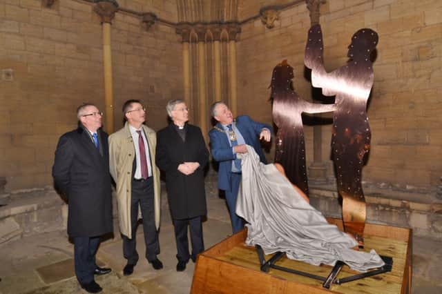 Mark Broadhead from Queensgate, Damian Evans HMP Peterborough direrctor, Jonathan Baker, acting Dean and Mayor David Sanders at the unvieling of the nativity sculpture in the  northern portico at Peterborough Cathedral which was crafted by a prisoner at HMP Peterborough EMN-161128-183209009