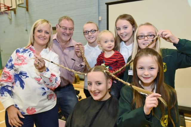 Yazmin Hills , a pupil of SHSCC Whittlesey, having her head shaved to raise funds for Cody Stanier (3) by hairdresser and mum Claire Hills. The event was being watched by her family members EMN-161125-152711009