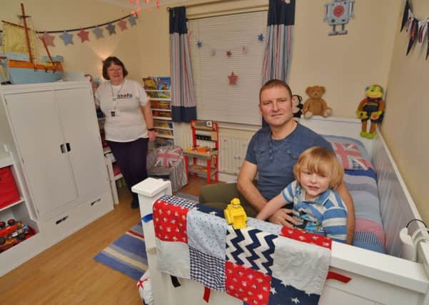 Sammy Owens (5) with his dad Nicky and Sandy Paterson from SSAFA in the new bedroom for Sammy at his home in Woodston EMN-161129-193211009
