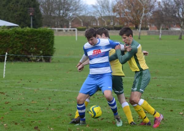Action from the Peterborough Premier Division game between Crowland (yellow) and Leverington. Leverington won 2-1. Photo: David Lowndes.