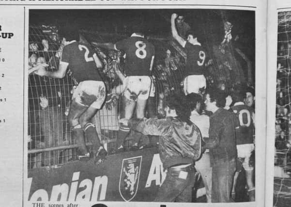 Posh players celebrate with their fans after a famous FA Cup win at Notts County.