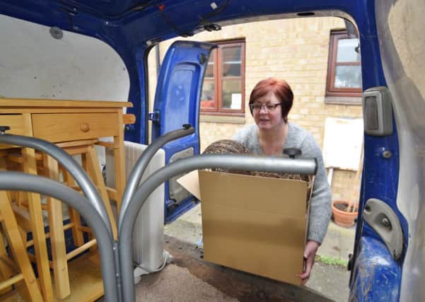 Beverley Nicholls with the help of removal men moving out of St Michael's Gate EMN-160312-221936009