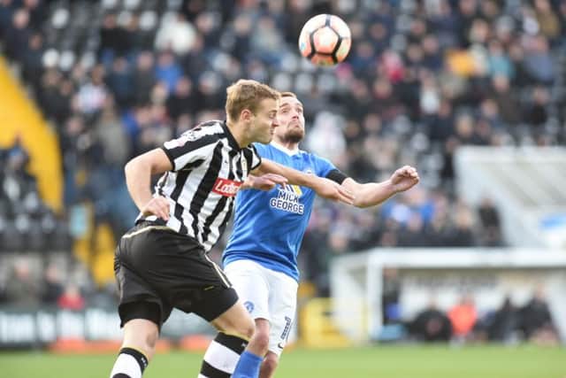 Posh striker Paul Taylor battles for possession at Notts County. Photo: David Lowndes.