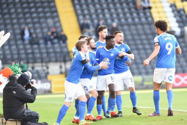 Posh players celebrate Leo Da Silva Lopes' early goal. Photo: David Lowndes.
