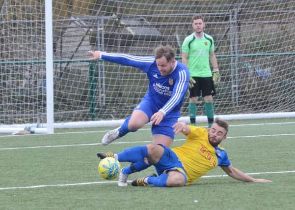 Action from Stamford Lions' 5-2 win in the PFA Senior Cup at AFC Stanground Sports (blue). Photo: David Lowndes.