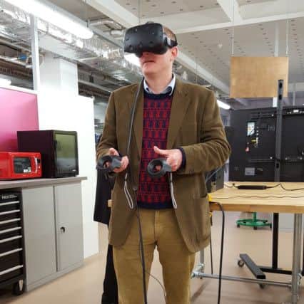 Simon Humphrey tries out the Virtual Reality headset in the Innovation Lab.